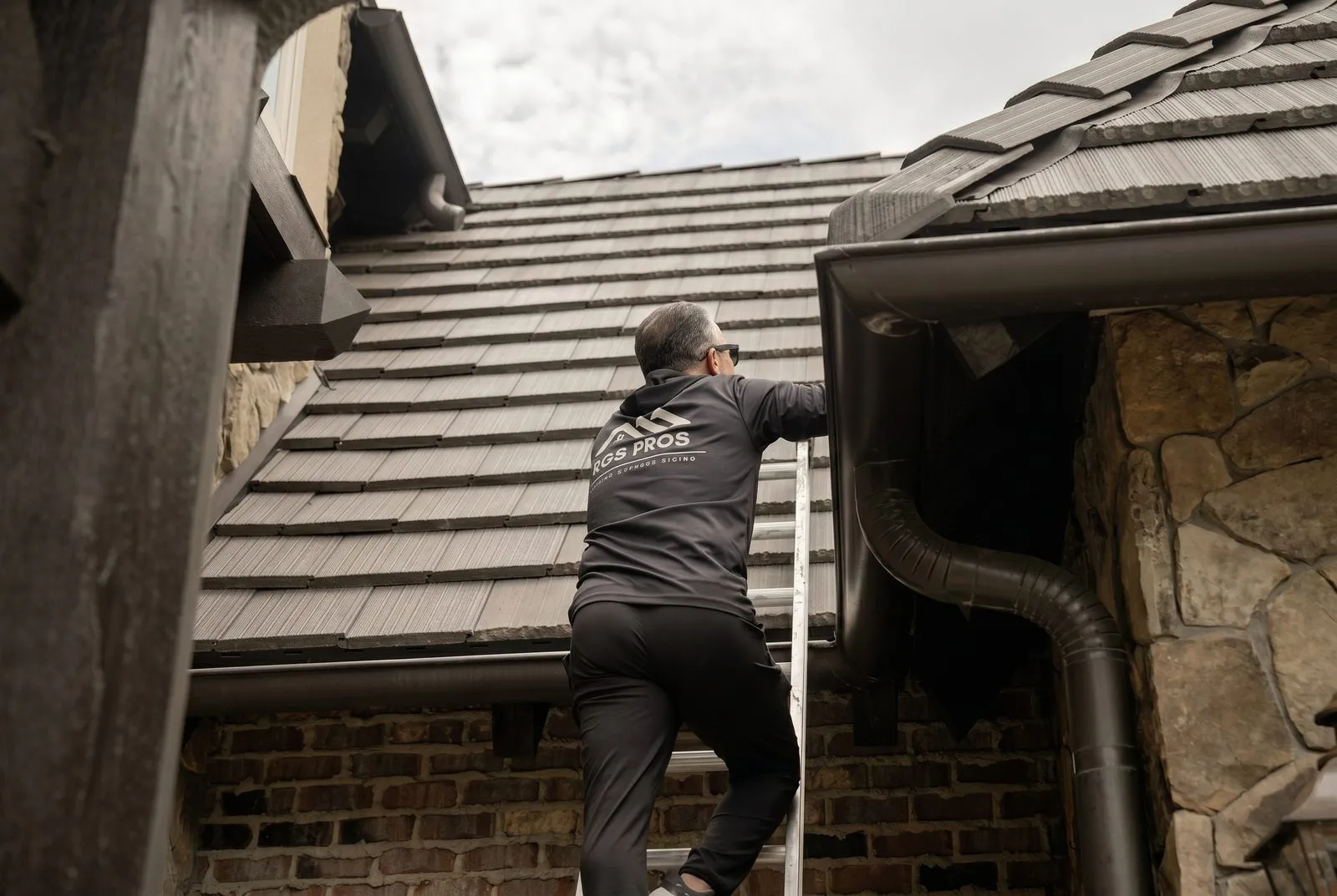 Tony Garay, owner of RGS Home Pros, heading up to inspect a roof